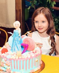 Girl looking at birthday cake