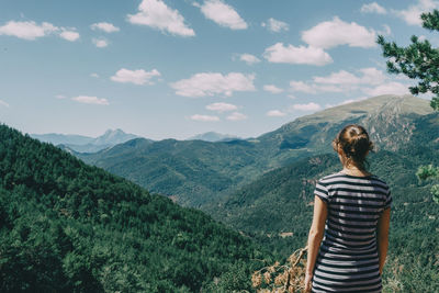 Girl walking along a small path in the mountain of spain. on a sunny summer day