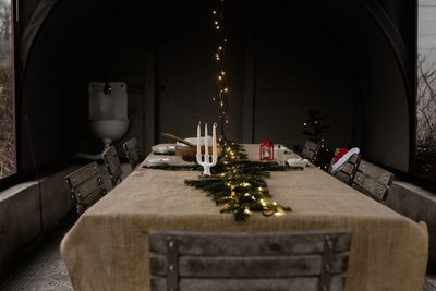 Traditional scandinavian dinner table with fairy lights & candle