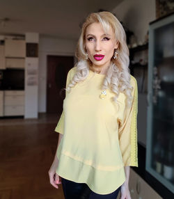 Portrait of beautiful woman standing at home