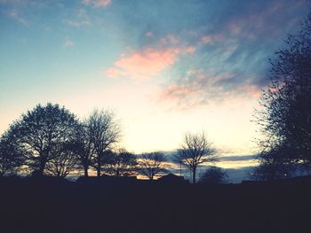 Silhouette of trees against sky at sunset