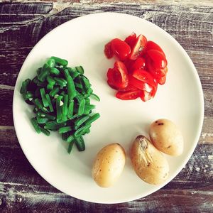 High angle view of chopped fruits in plate on table