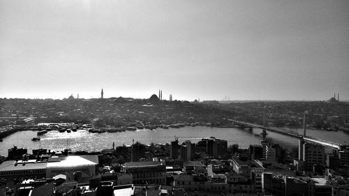 High angle view of buildings by river against sky