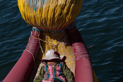 Portrait of woman in pink hat on lake