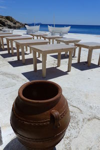 High angle view of pot by tables on beach