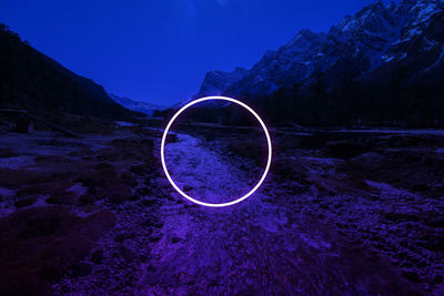 Light painting on rock against sky at night