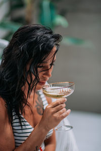 Midsection of woman drinking glass