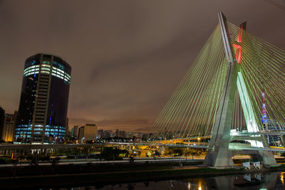 Illuminated city against sky at night