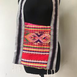 Close-up of multi colored flags hanging against wall