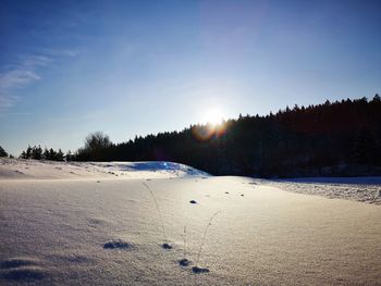 Scenic view of snow covered landscape against sky