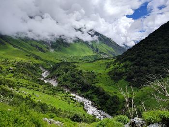 Scenic view of mountains against cloudy sky