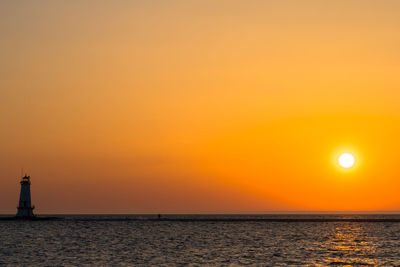 Scenic view of sea against orange sky