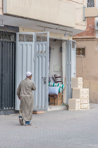 Rear view of man standing at office building