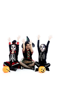 Portrait of mother with toys against white background