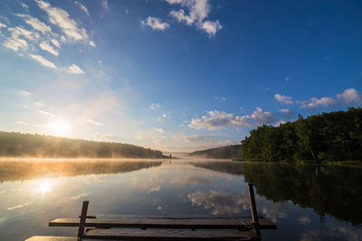 Scenic view of lake against sky with wooden pier