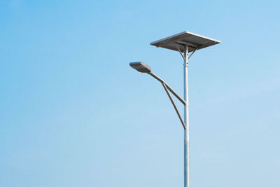 Low angle view of street light against clear blue sky