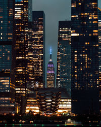 Low angle view of illuminated buildings in city at night