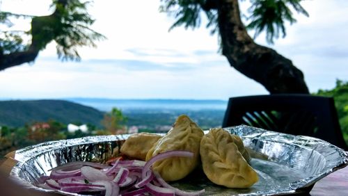 Close-up of fruits on table against the sky