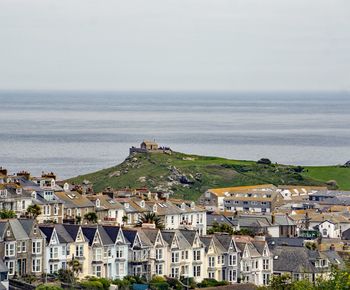 High angle view of buildings and sea against sky