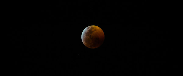 Low angle view of moon against sky at night
