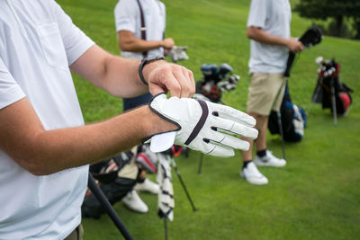 Midsection of man preparing for golf