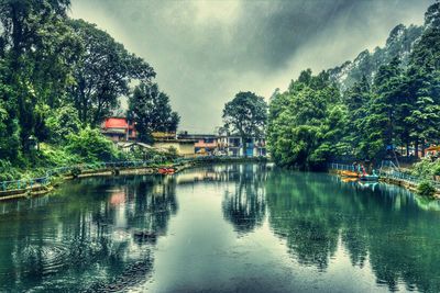 Scenic view of river against cloudy sky