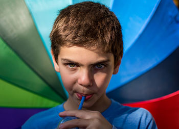Portrait of boy drinking from straw