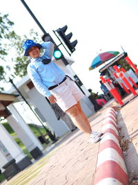 Low angle view of man holding umbrella against sky