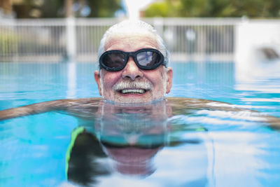 Portrait of man swimming in pool