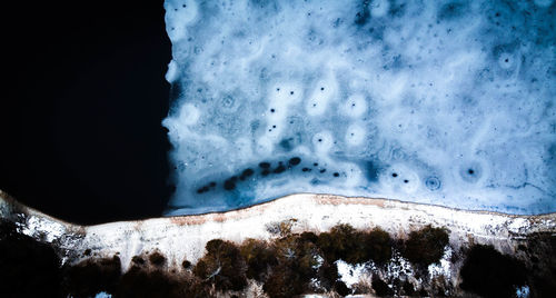 Low angle view of snowcapped mountains against sky at night