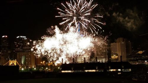 Low angle view of firework display at night