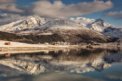 Scenic view of lake and snowcapped mountains against sky