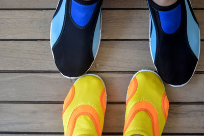 Low section of woman standing on hardwood floor
