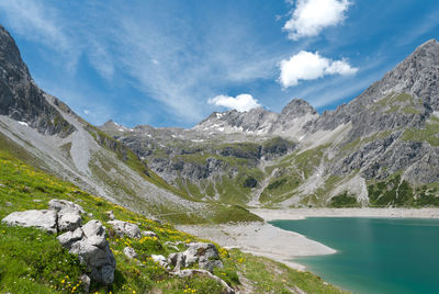 Scenic view of lake and mountains against sky