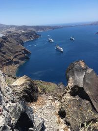 High angle view of rocks in sea against clear sky