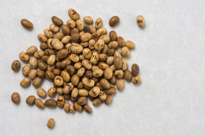 High angle view of coffee beans on white background