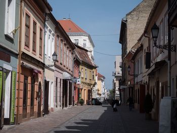 Street amidst buildings against clear sky