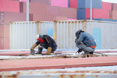 Side view of man working at railroad station