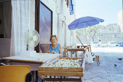 Woman sitting on table