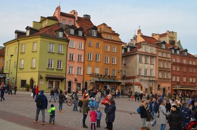 People on street amidst buildings in city