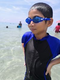 Boy wearing sunglasses on beach