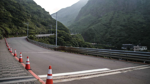 Road by mountain against sky