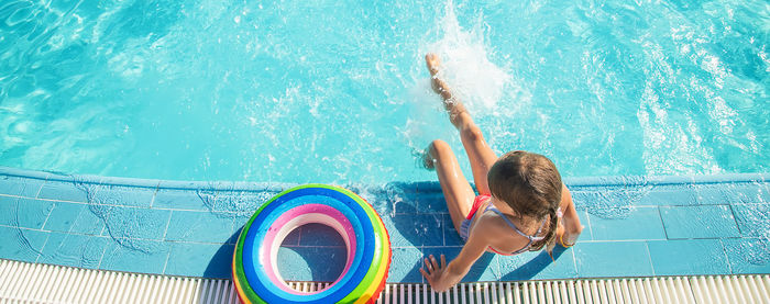 Rear view of woman swimming in sea