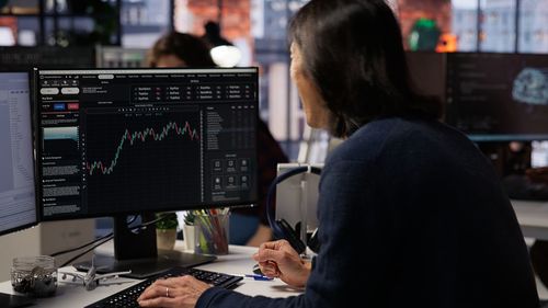 Rear view of man working at office