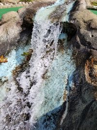 High angle view of water flowing through rocks