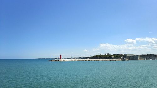 Scenic view of sea against blue sky