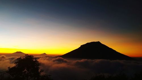 Scenic view of silhouette mountains against sky during sunset