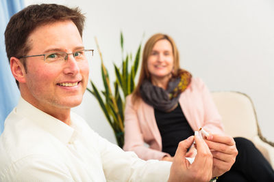 Portrait of smiling young couple sitting