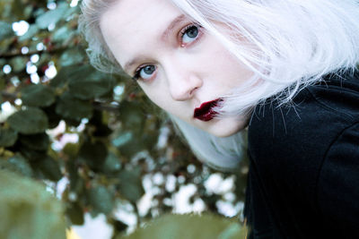 Close-up portrait of young woman with dyed hair 