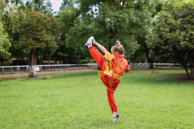 Full length of woman standing on field